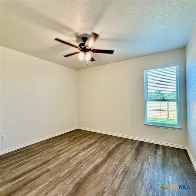 unfurnished room with dark hardwood / wood-style flooring, a textured ceiling, and ceiling fan