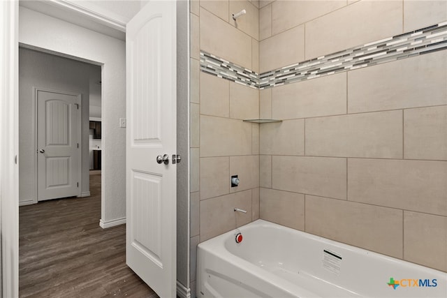 bathroom with tiled shower / bath combo and hardwood / wood-style floors