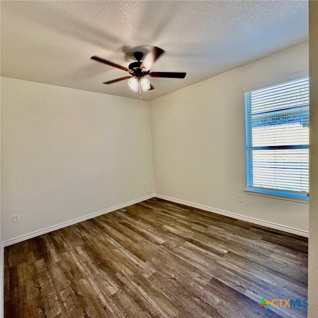 unfurnished room featuring ceiling fan, a textured ceiling, and dark hardwood / wood-style floors