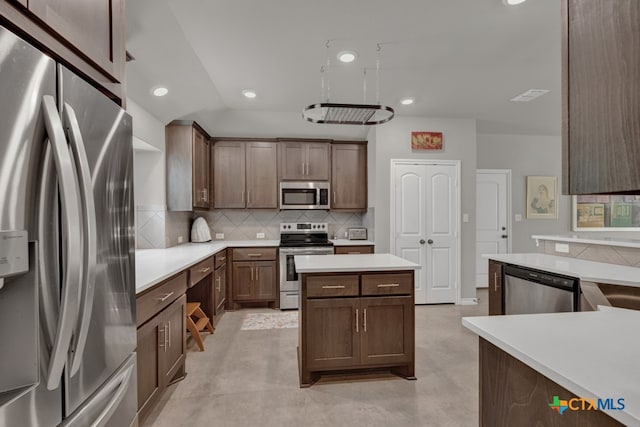 kitchen with stainless steel appliances, tasteful backsplash, and vaulted ceiling