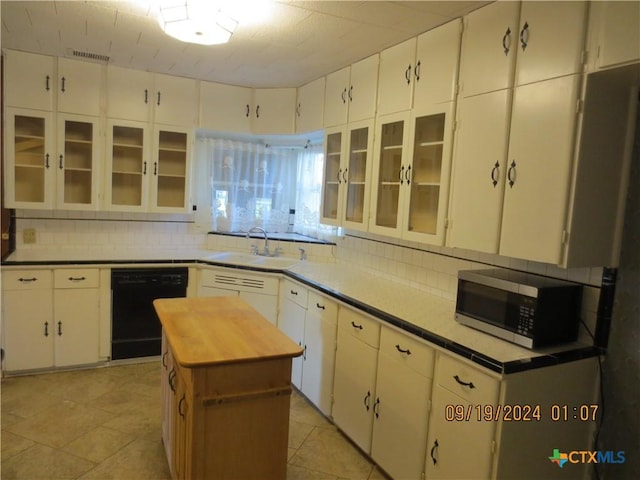 1124 Refugio Hwy, Victoria, TX 77905 - kitchen featuring stainless steel microwave, black dishwasher, a sink, decorative backsplash, and butcher block counters