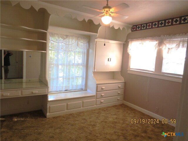 unfurnished bedroom featuring dark colored carpet and ornamental molding