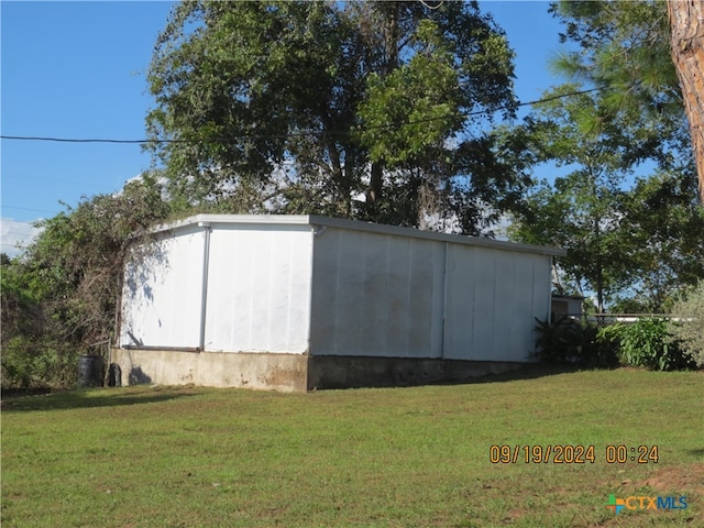 view of outbuilding with a yard