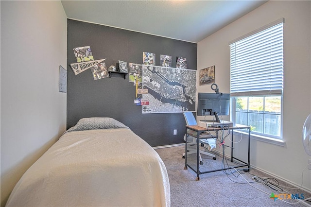 carpeted bedroom featuring baseboards