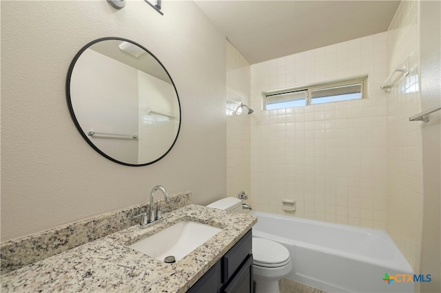 full bathroom with vanity, tiled shower / bath combo, and toilet