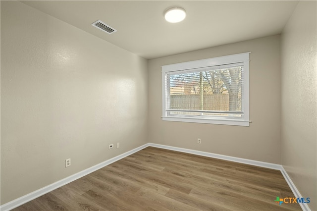 spare room featuring hardwood / wood-style floors