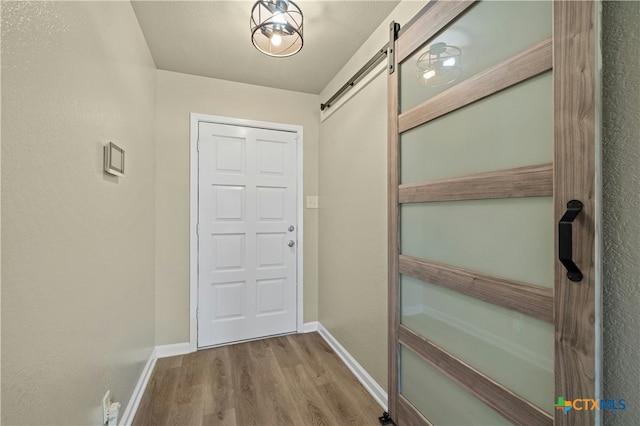 interior space with hardwood / wood-style flooring and a barn door