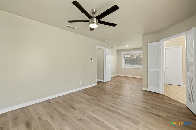 spare room featuring ceiling fan and light hardwood / wood-style floors