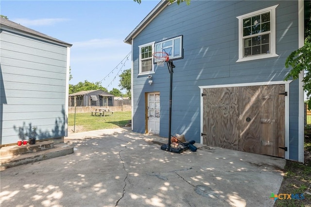 1107 Waco St, Gatesville, TX 76528 - view of side of property with an attached garage, a patio area, and concrete driveway