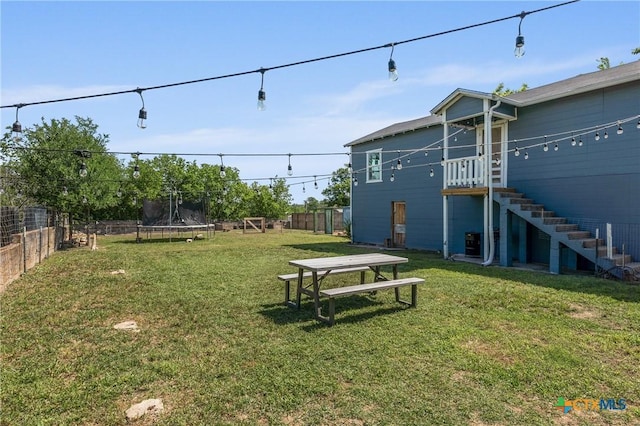 1107 Waco St, Gatesville, TX 76528 - view of yard with a trampoline, stairs, and central AC unit
