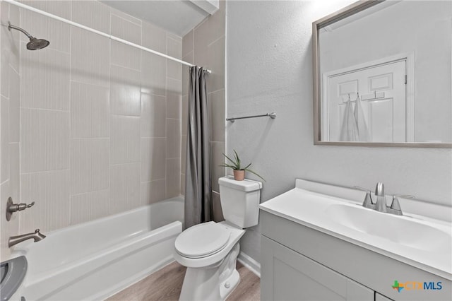 1107 Waco St, Gatesville, TX 76528 - bathroom with shower / bath combination with curtain, toilet, wood finished floors, and vanity