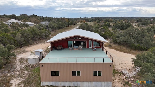 drone / aerial view featuring a wooded view