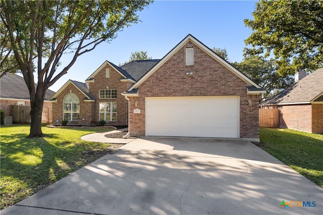 view of front of house with a garage and a front yard