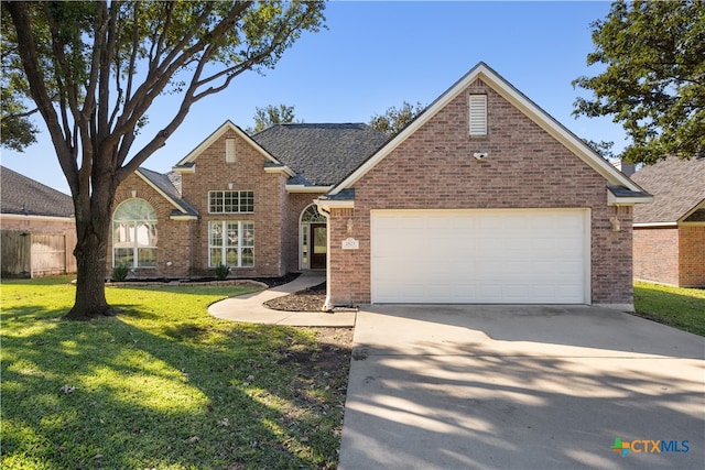 view of front facade with a garage and a front yard