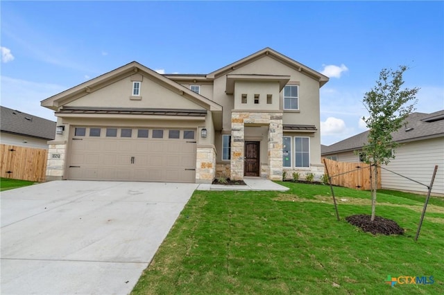 view of front of home with a front yard and a garage