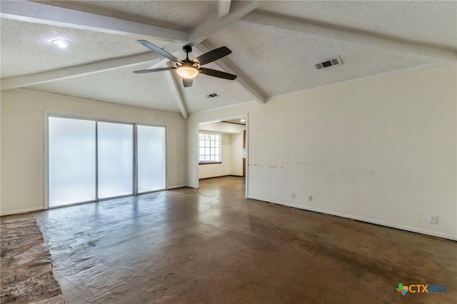 empty room featuring a textured ceiling, lofted ceiling with beams, and ceiling fan