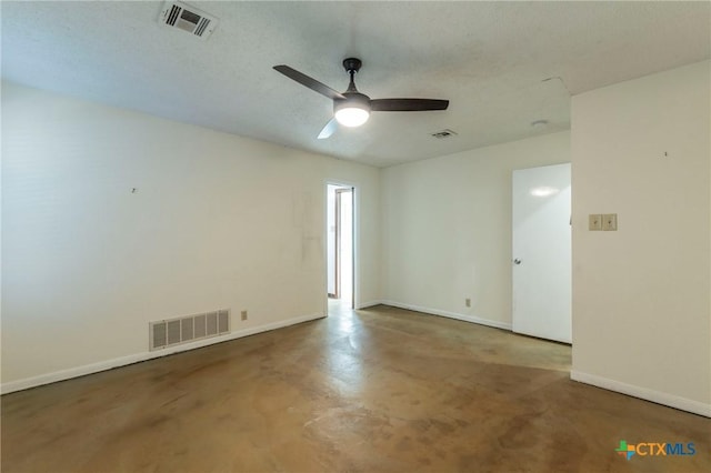 unfurnished room with ceiling fan, concrete flooring, and a textured ceiling