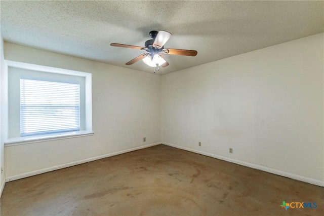 carpeted spare room with ceiling fan and a textured ceiling