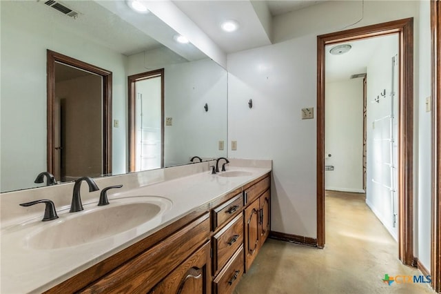 bathroom with vanity and concrete floors