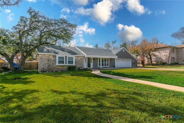 single story home with a garage and a front lawn