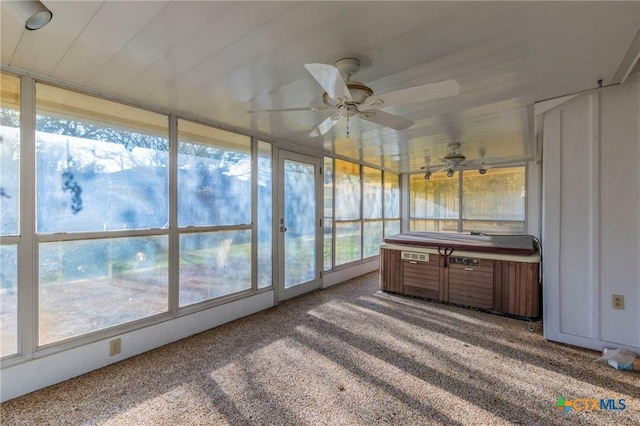 sunroom with ceiling fan and a hot tub