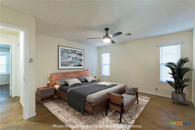 bedroom with carpet flooring, ceiling fan, and a textured ceiling