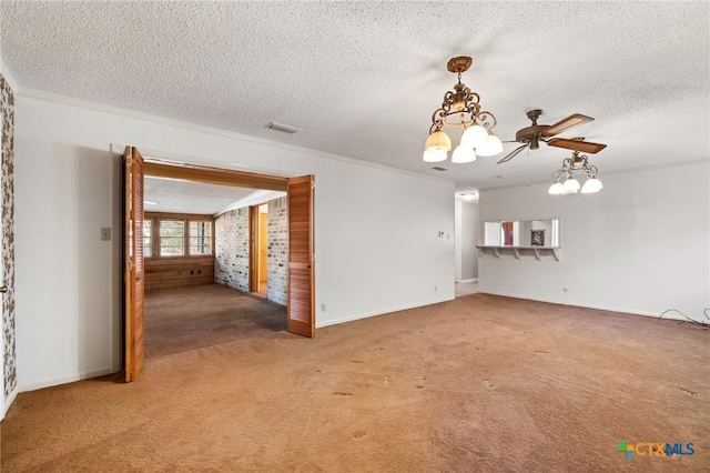 unfurnished living room with carpet floors, a textured ceiling, and crown molding