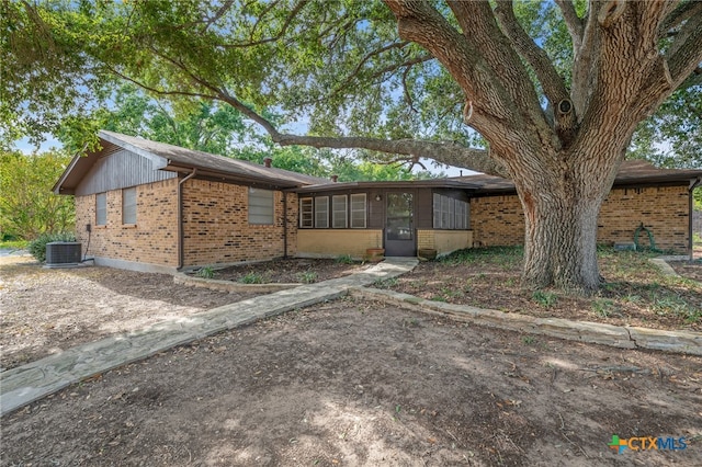 ranch-style home featuring cooling unit