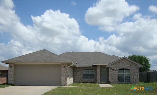 single story home with a garage and a front yard