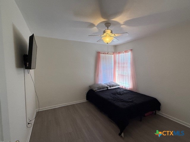 bedroom with dark wood-type flooring and ceiling fan