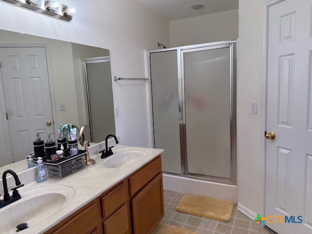 bathroom featuring vanity and a shower with shower door