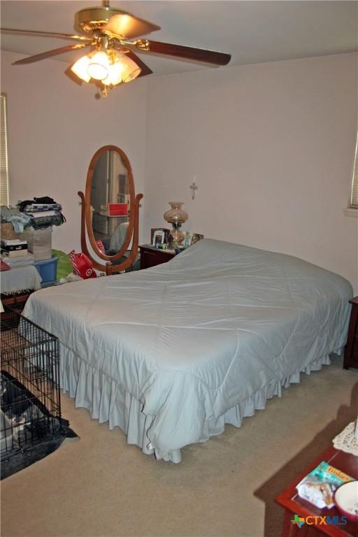 bedroom with ceiling fan and carpet flooring