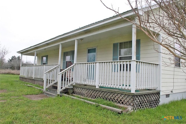 back of property with a yard and covered porch