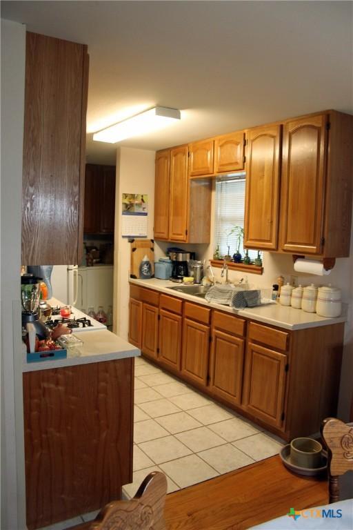 kitchen with sink and light tile patterned floors