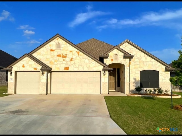 1527 Cobble Hill Ct, Temple, TX 76502 - french provincial home with a garage, driveway, stone siding, and a front lawn