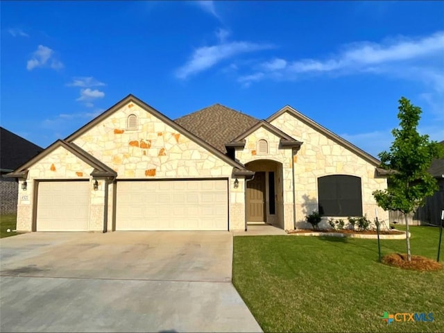 1527 Cobble Hill Ct, Temple, TX 76502 - french provincial home with a garage, driveway, a front yard, and stone siding