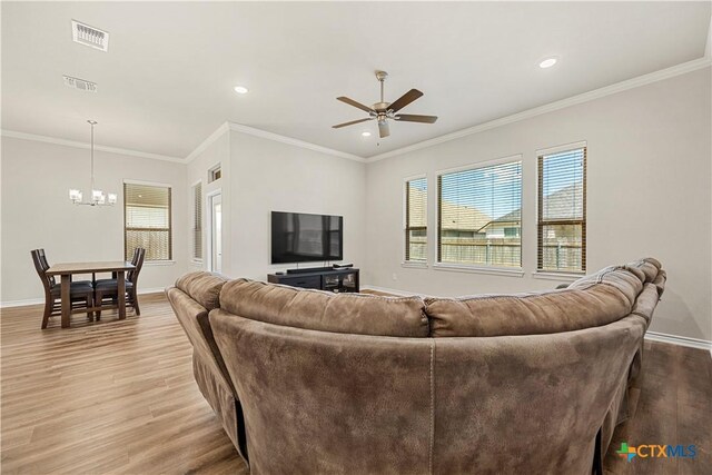 1527 Cobble Hill Ct, Temple, TX 76502 - living area featuring wood finished floors, a chandelier, a ceiling fan, healthy amount of natural light, and recessed lighting