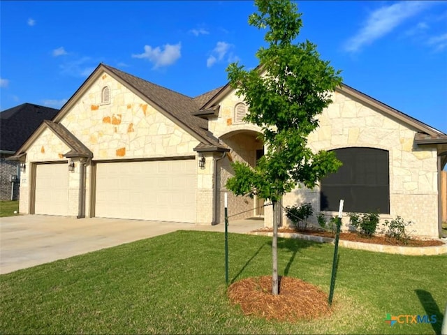 1527 Cobble Hill Ct, Temple, TX 76502 - french provincial home with stone siding, a garage, driveway, and a front lawn