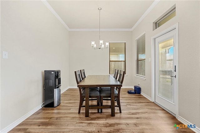 1527 Cobble Hill Ct, Temple, TX 76502 - dining area with light wood finished floors, a chandelier, crown molding, and baseboards