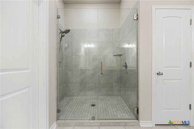 1527 Cobble Hill Ct, Temple, TX 76502 - bathroom featuring a shower stall, tile patterned floors, and baseboards