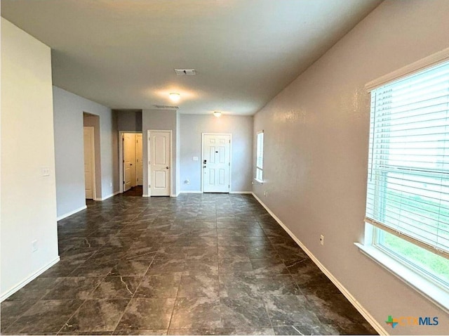 spare room featuring visible vents and baseboards