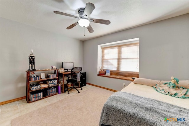 bedroom featuring light tile patterned floors, baseboards, a ceiling fan, and light colored carpet