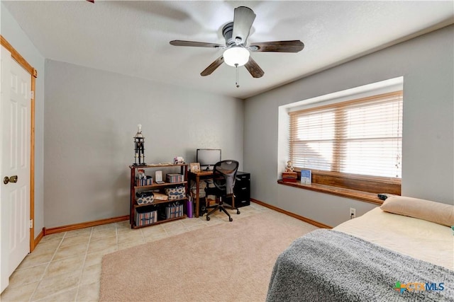 bedroom with light tile patterned floors, ceiling fan, baseboards, and light colored carpet