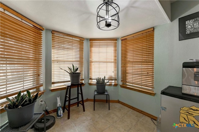 office featuring baseboards and a chandelier