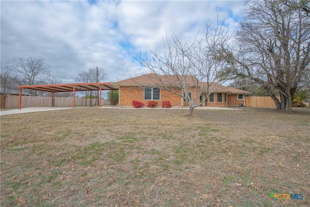 ranch-style home with a carport and a front yard