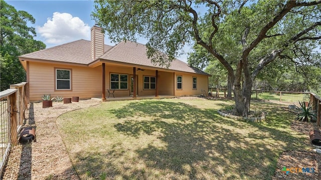 7881 Wegner Rd, New Braunfels, TX 78132 - back of house featuring ceiling fan, a chimney, a patio area, and a shingled roof