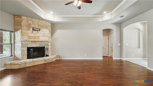 7881 Wegner Rd, New Braunfels, TX 78132 - unfurnished living room featuring a raised ceiling, crown molding, ceiling fan, wood finished floors, and a fireplace
