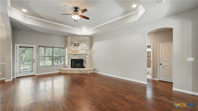 7881 Wegner Rd, New Braunfels, TX 78132 - unfurnished living room featuring a raised ceiling, a ceiling fan, crown molding, hardwood / wood-style flooring, and arched walkways
