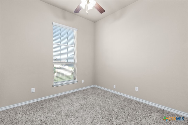 unfurnished room featuring carpet flooring, a wealth of natural light, and ceiling fan