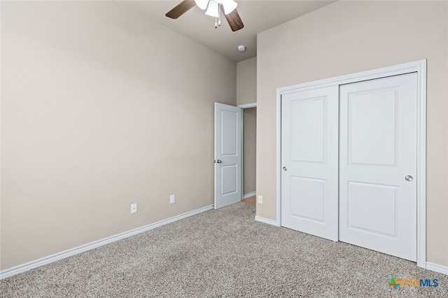 unfurnished bedroom with carpet flooring, ceiling fan, and a closet